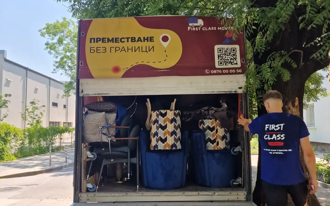 A loaded First Class Movers truck and a mover during a home move