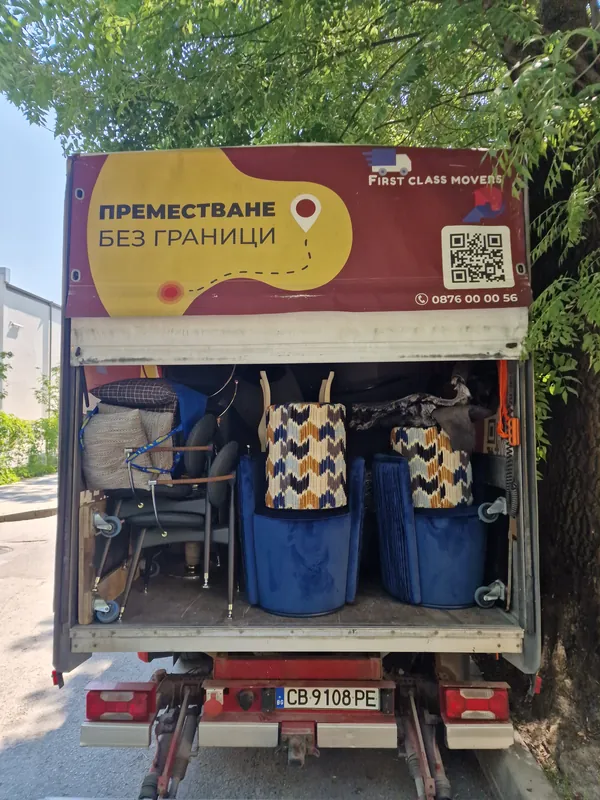 A loaded First Class Movers truck with furniture and belongings