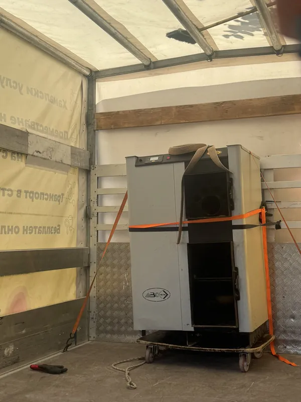 A cabinet secured with straps in the truck’s cargo area