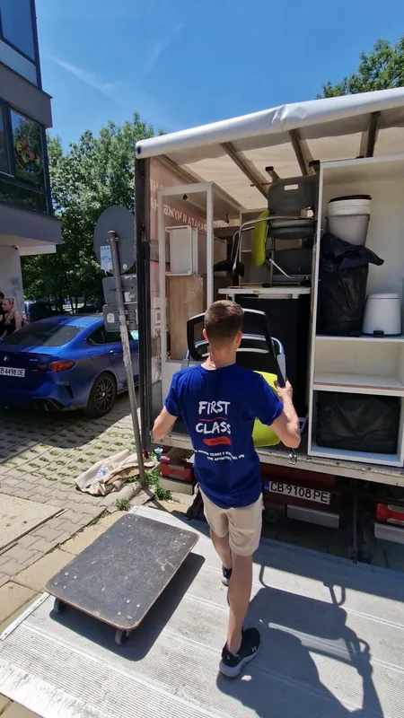 A mover loading furniture into a truck in Sofia